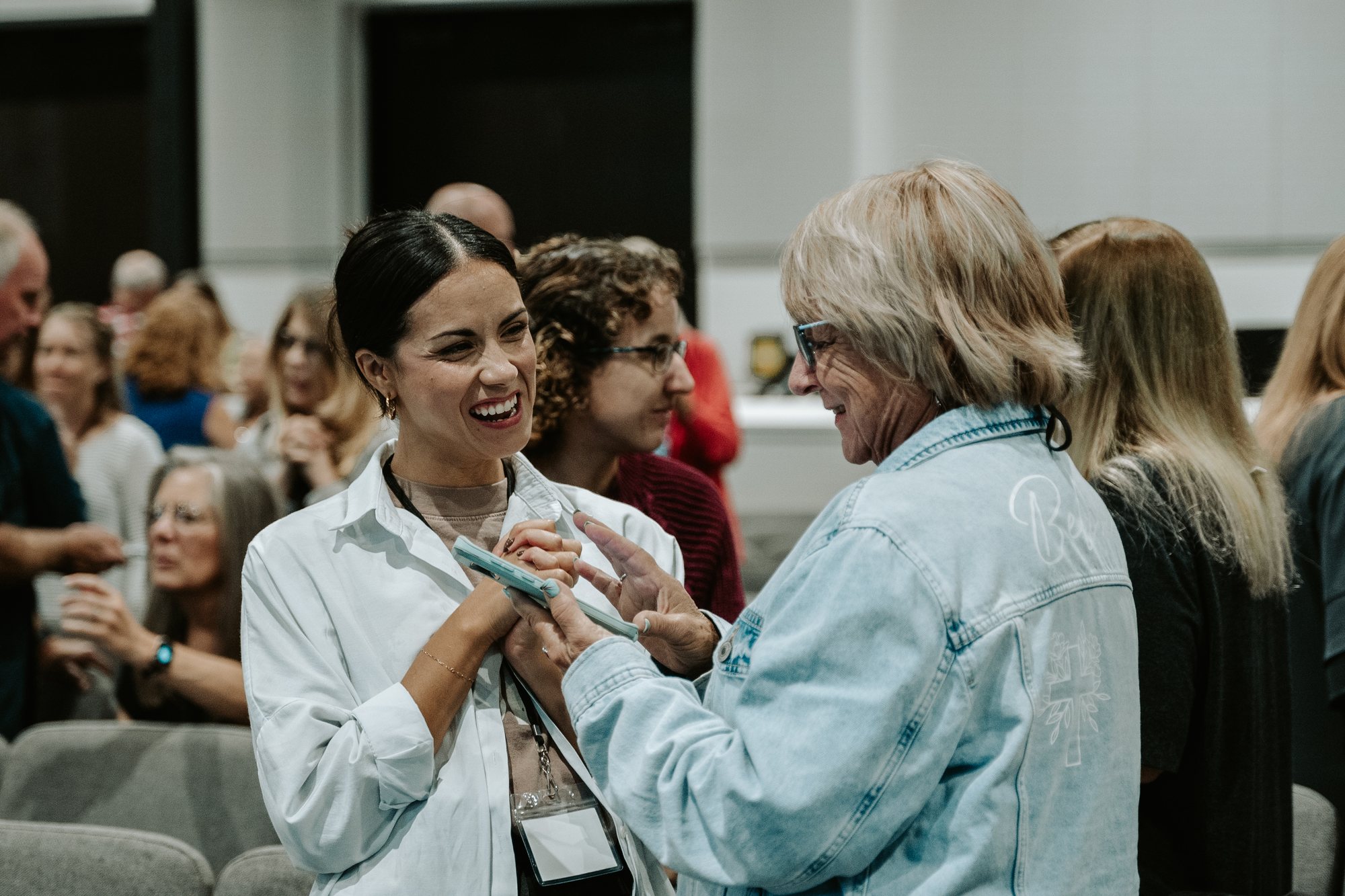 Two attendees sharing a prophetic word with each other during a live activation.